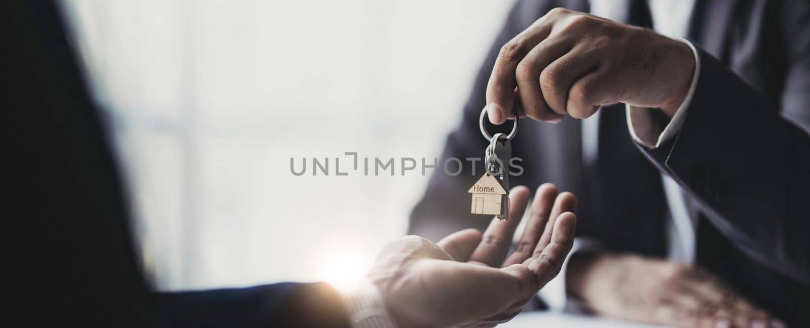 Real estate agents agree to buy a home and give keys to clients at their agency's offices. Concept agreement..