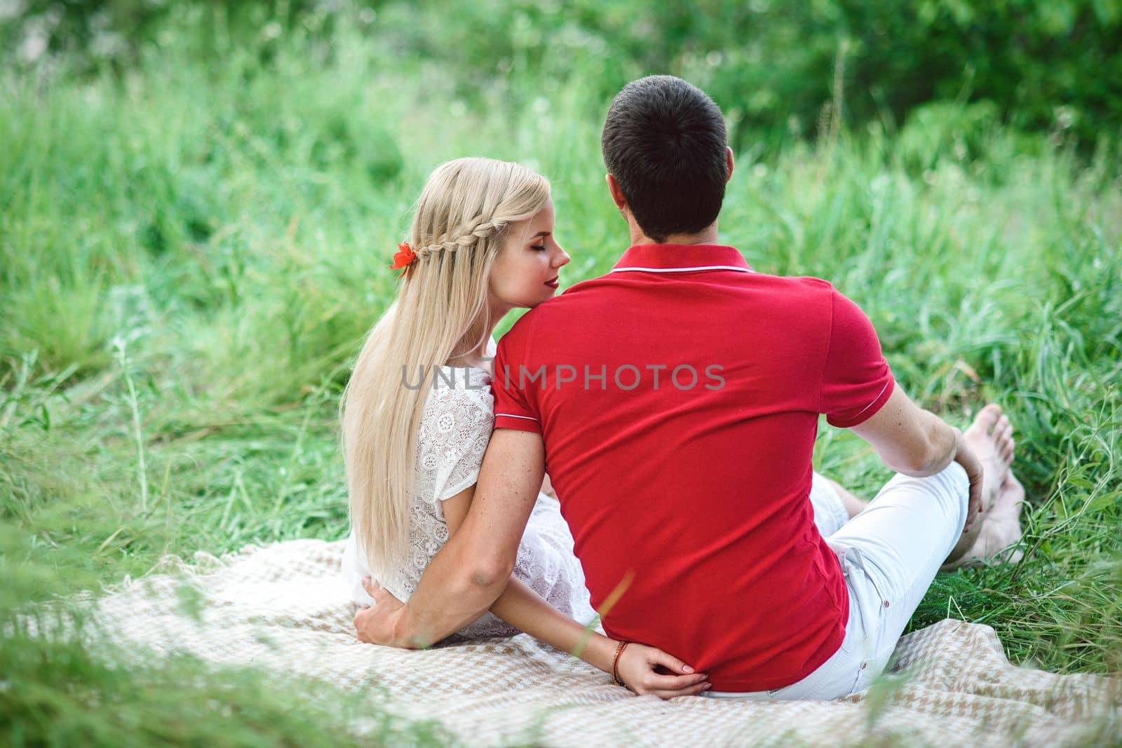 couple in love at a picnic in a park with green grass by Andreua