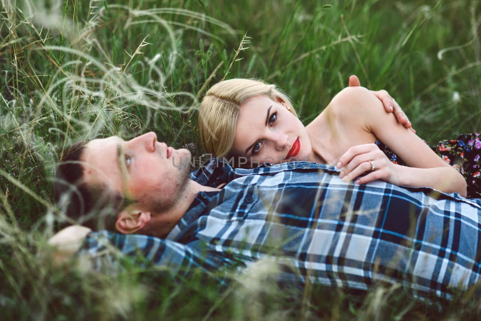 couple in love blonde girl and guy in the grass by Andreua