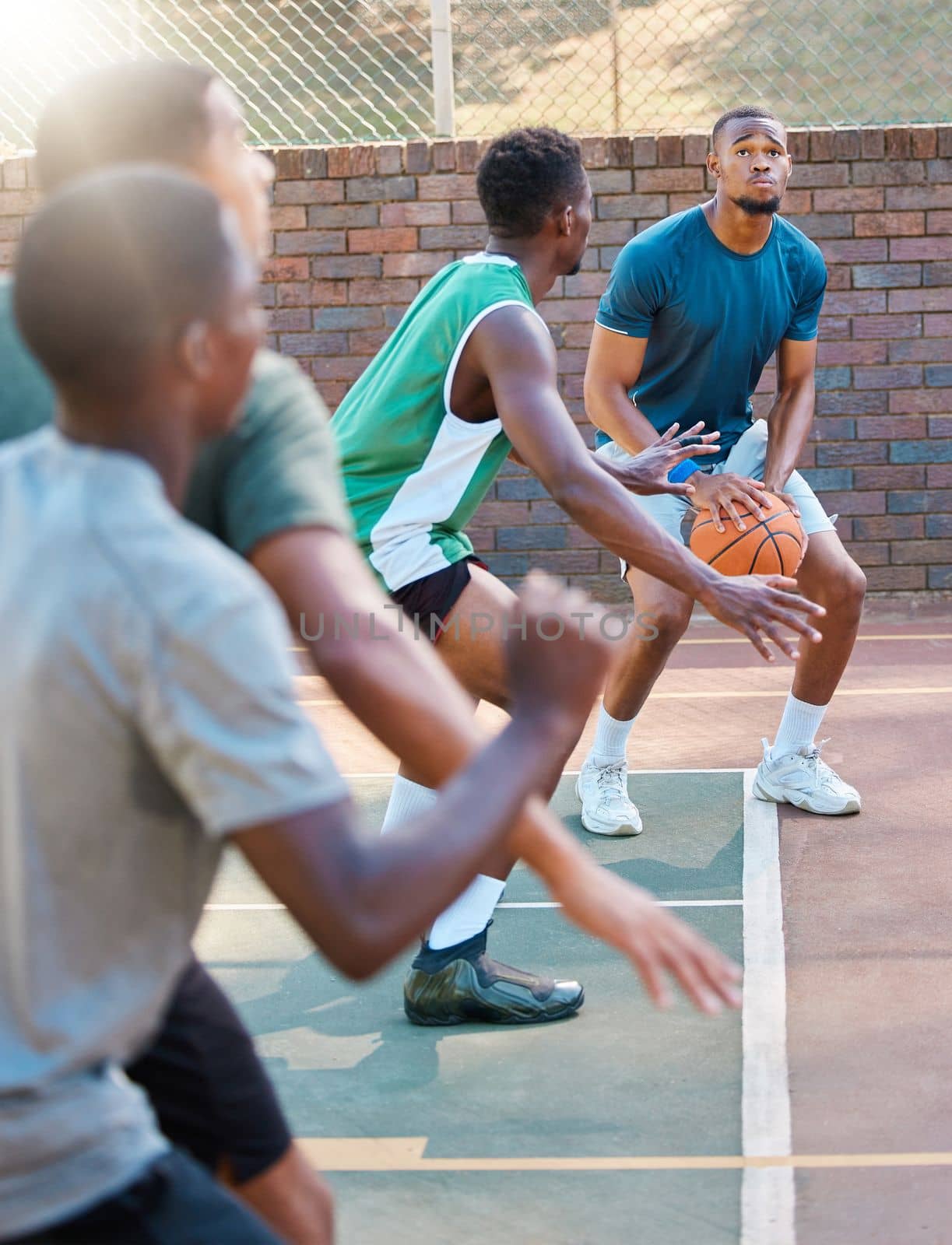 Basketball, game and team sports for match point, score or ready for a shot at the basketball court. Basketball players in sport fitness, exercise or workout at the court together in the outdoors by YuriArcurs