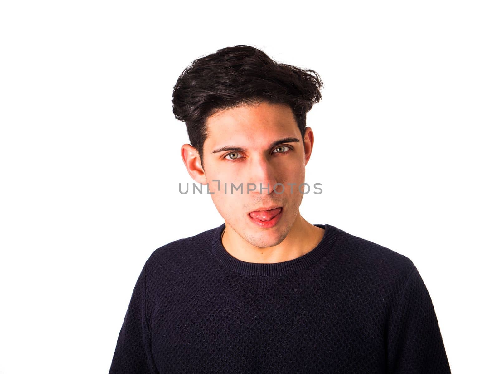 Attractive young man doing fun expression sticking out tongue by artofphoto