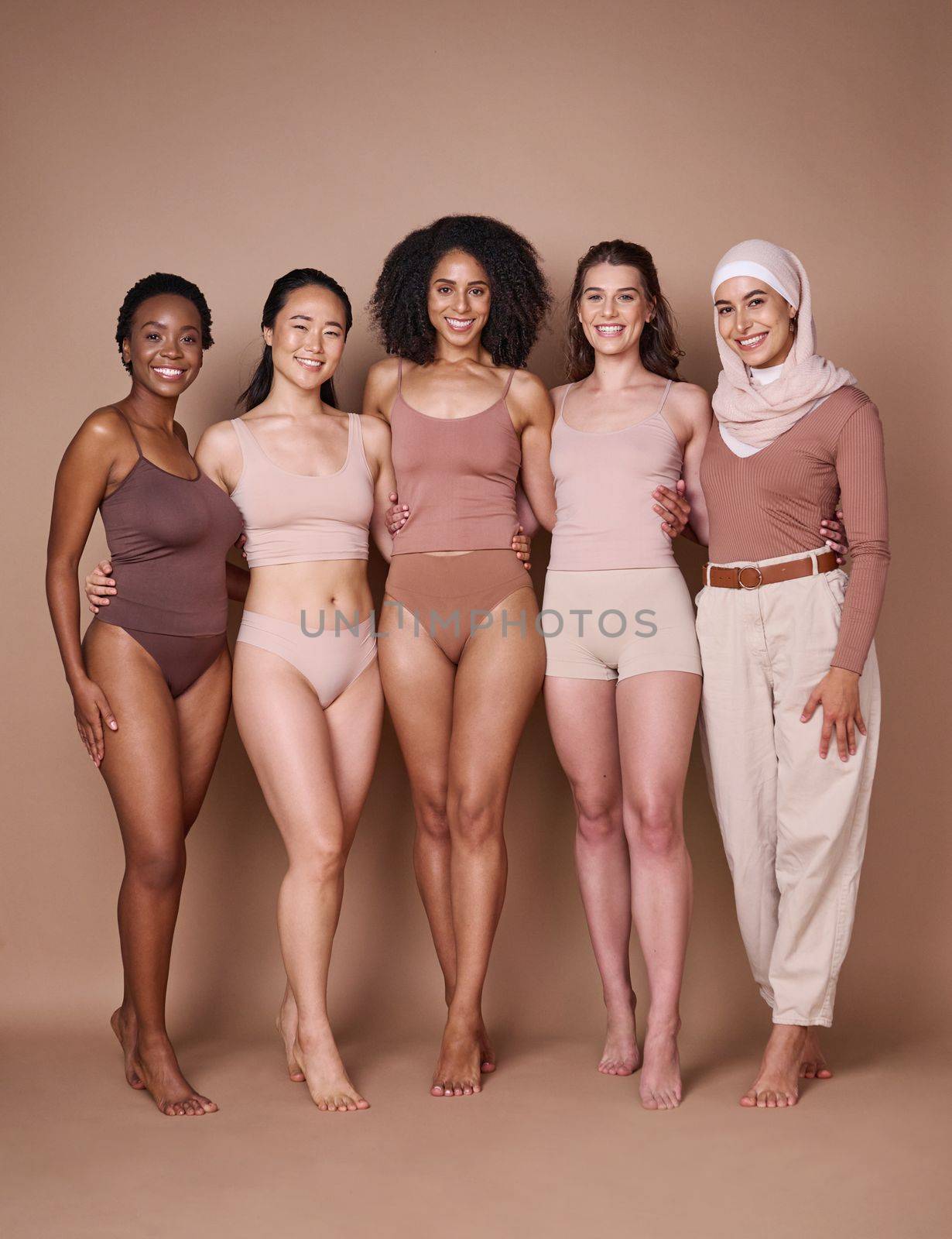 Beauty, diversity and body positivity with a woman friends together in studio on a brown background for inclusion. Portrait, model and underwear with a female friend group standing proud in unity.