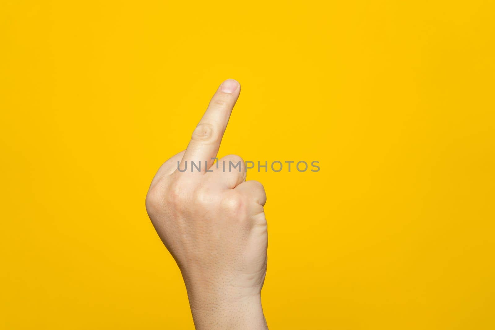 Finger hand symbols concept isolated sign of the middle finger in a gesture meaning fuck you or fuck off on yellow background