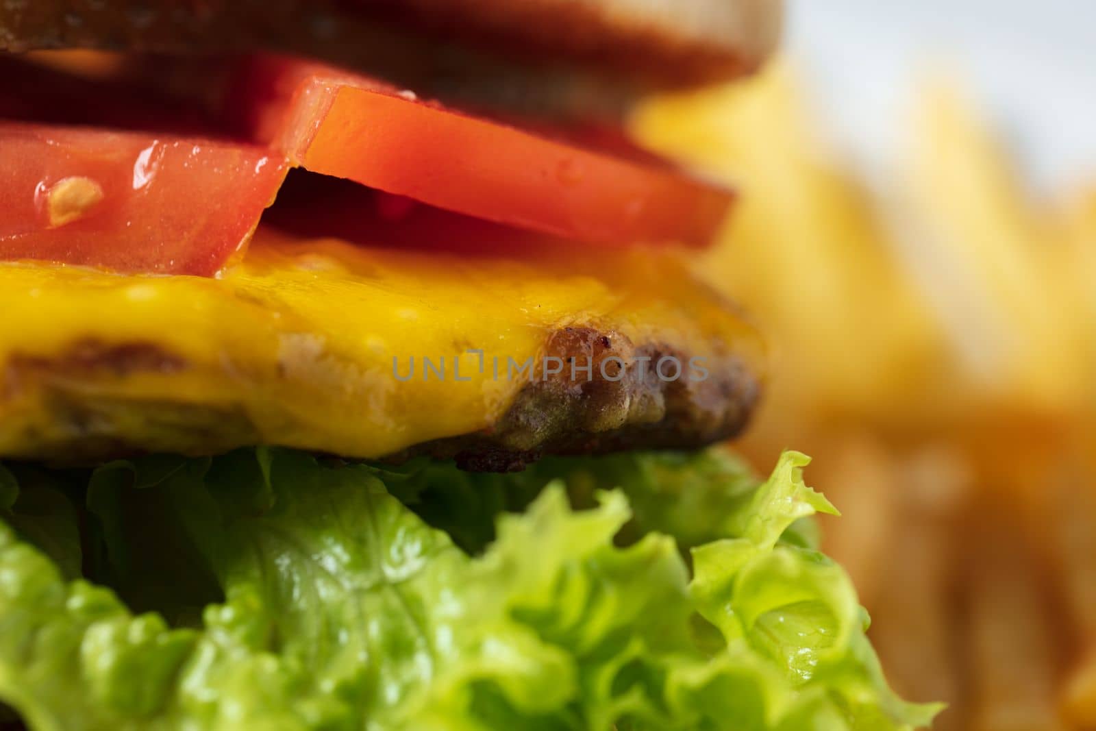 Cheeseburger with tomato and lettuce . High quality photo