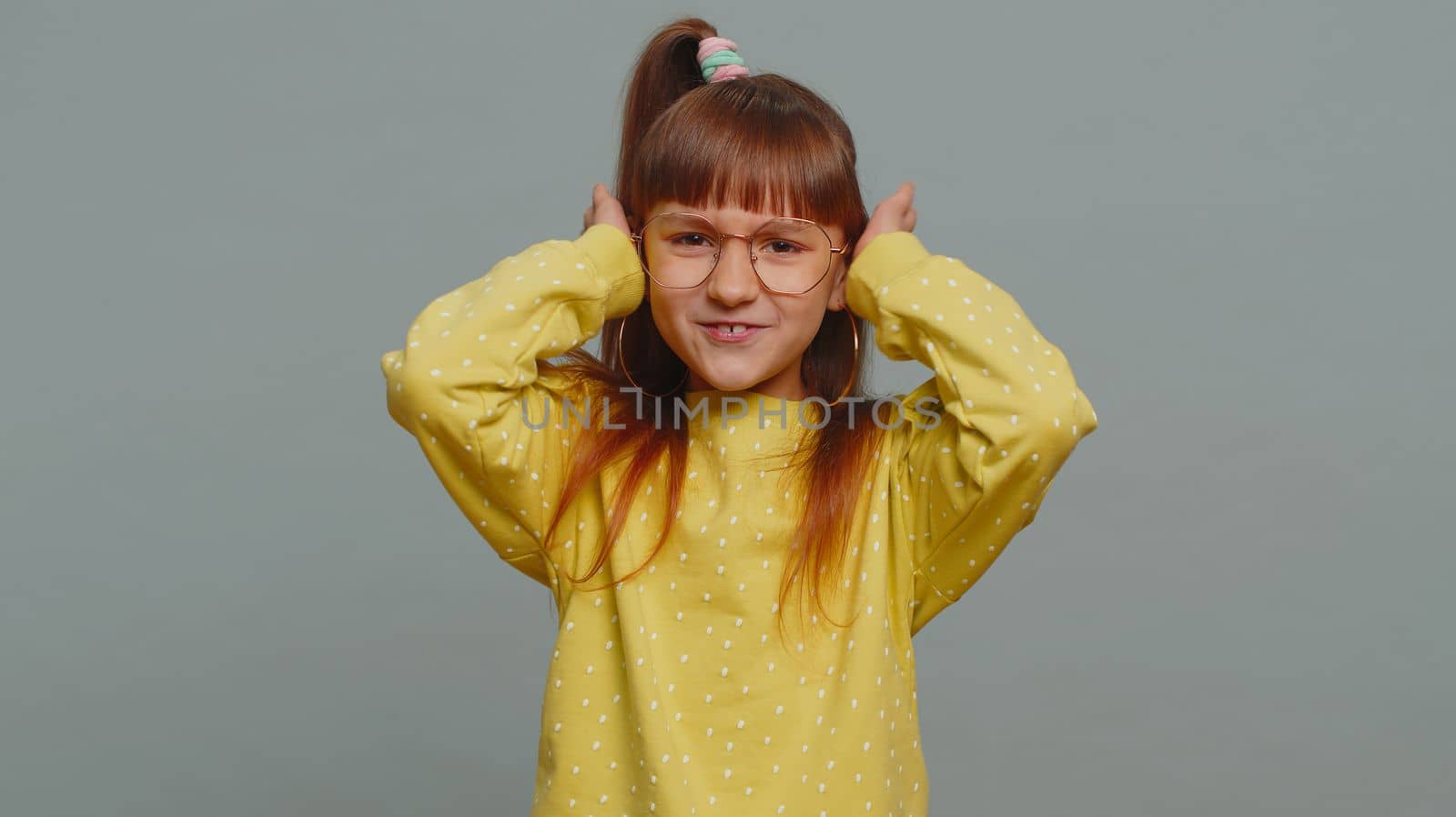 Dont want to hear, listen. Frustrated annoyed irritated young toddler school girl in glasses covering ears, gesturing No, avoiding advice ignoring unpleasant noise loud voices. Teen female child kid