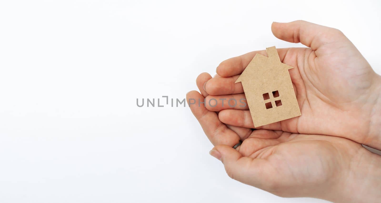 hands holding paper house, family home, homeless housing, mortgage crisis and home protecting insurance concept, foster home care, family day care, social distancing by Matiunina