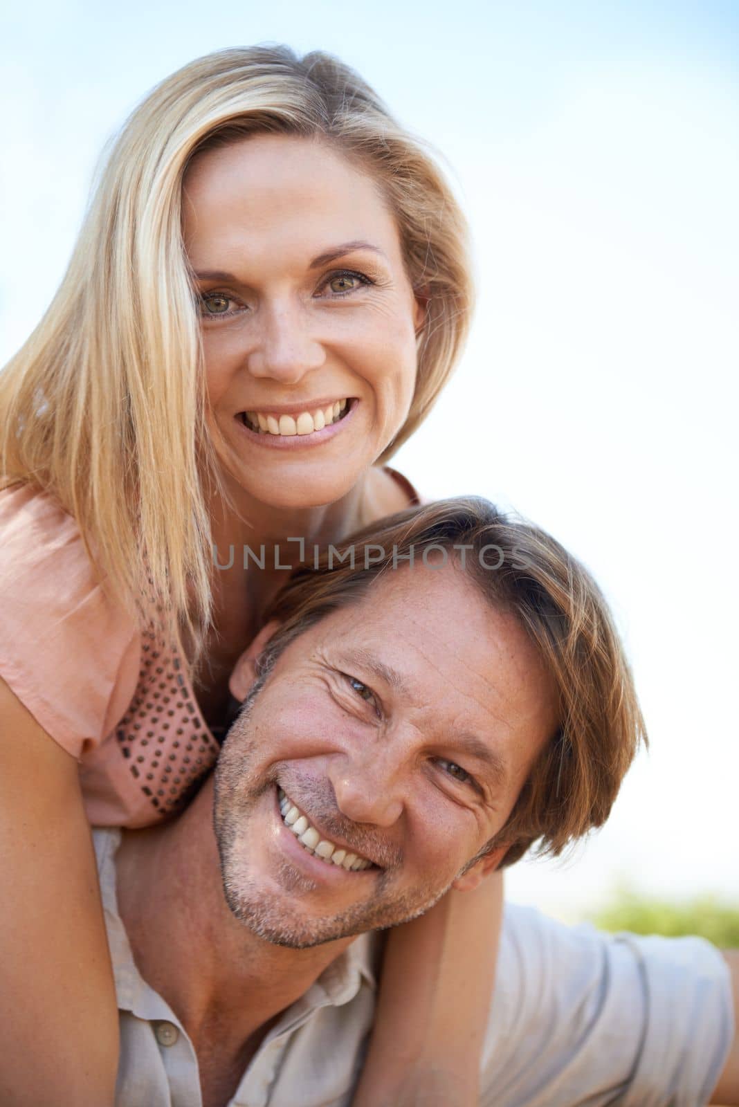 The secret to their love is. a happy mature enjoying a piggyback ride outdoors