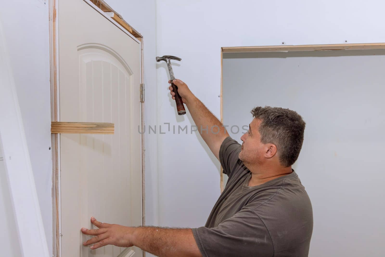 As trim carpenter, during installation of new house, hammer are used to attach doors to interior