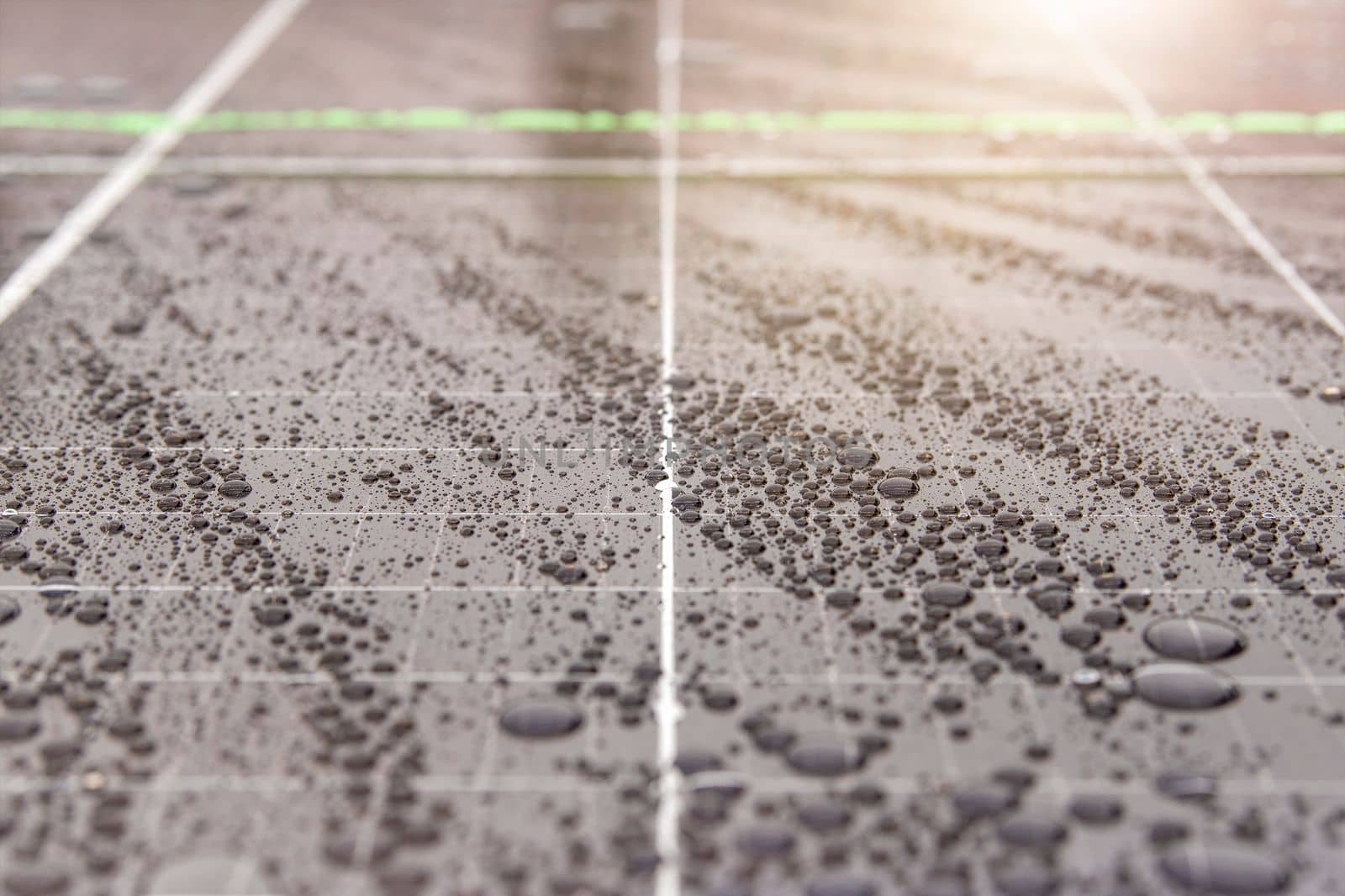 Green energy. Solar panels with raindrops close up. The use of waterproof solar panels in difficult environments, the production of green energy. by SERSOL