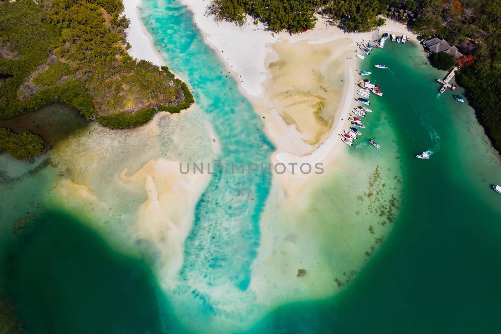 Aerial picture of the east coast of Mauritius Island. Beautiful lagoon of Mauritius Island shot from above. Boat sailing in turquoise lagoon.