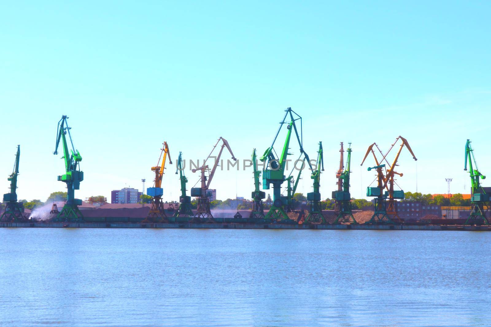 Blurred background, out of focus. View of the cranes in the port