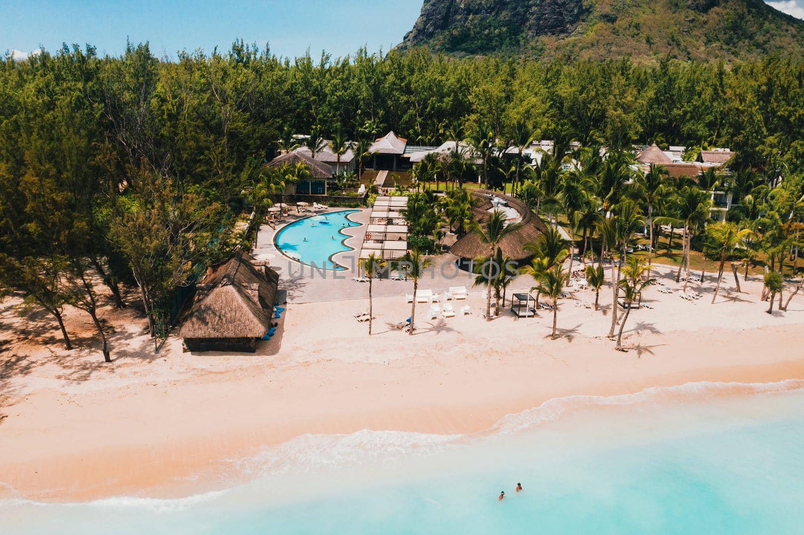 A bird's-eye view of the beach near the resort and the ocean next to mount Le Morne Brabant.Coral reef of the island of Mauritius.