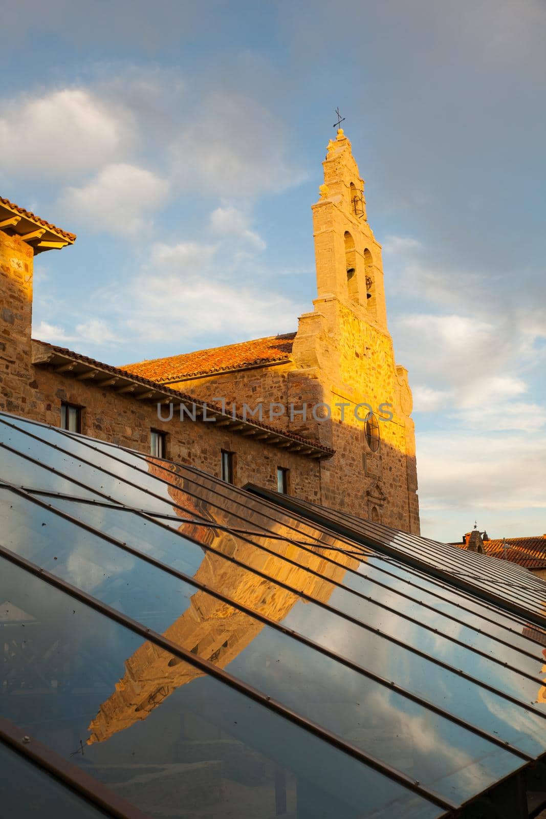 View of the San Francesco Church reflected on the glass cover of the museum in Astorga, Spain