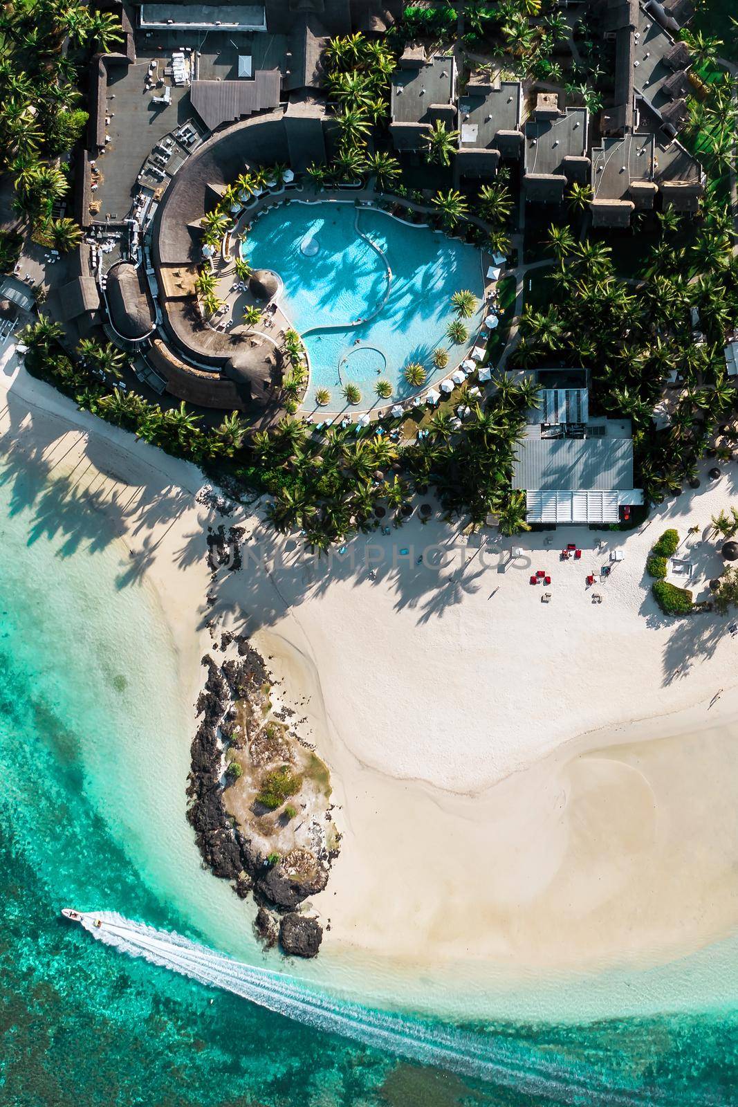 View from the height of the east coast of the island of Mauritius. Flying over the turquoise lagoon of the island of Mauritius in the area of Bel Mare