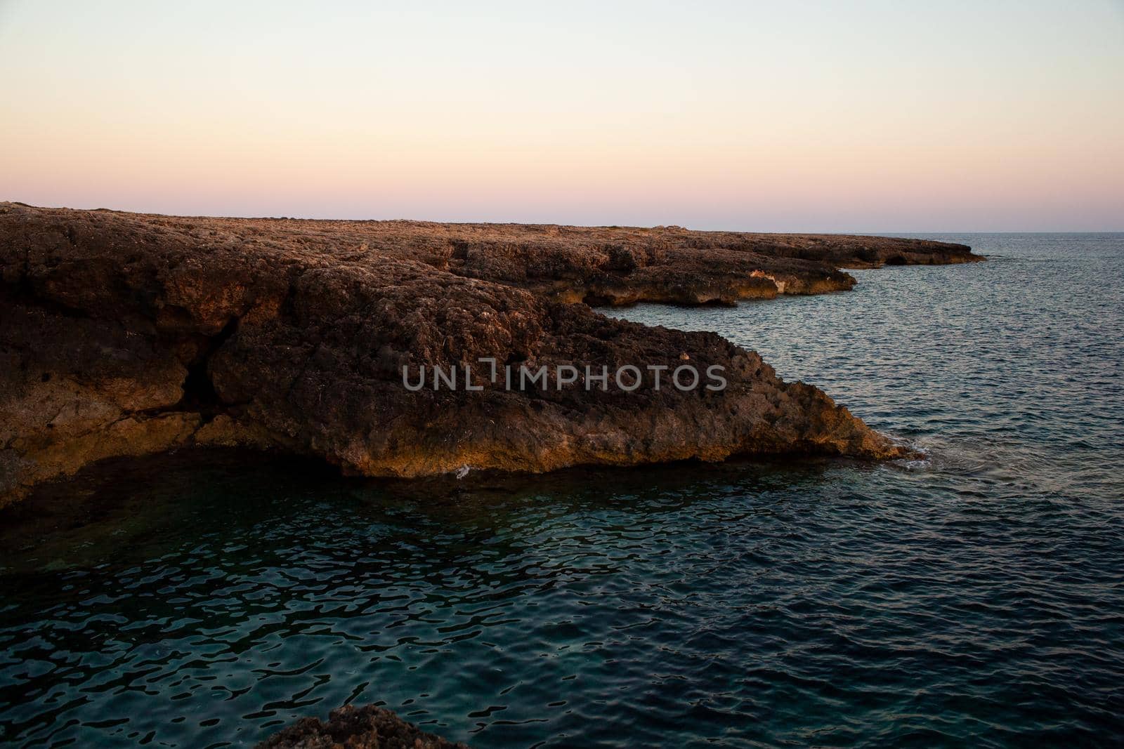 Rock coast of Lampedusa at sunset, Sicily