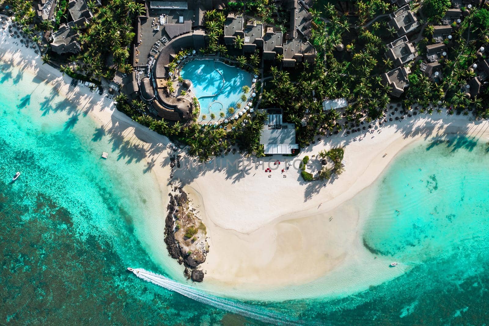 View from the height of the east coast of the island of Mauritius. Flying over the turquoise lagoon of the island of Mauritius in the area of Bel Mare