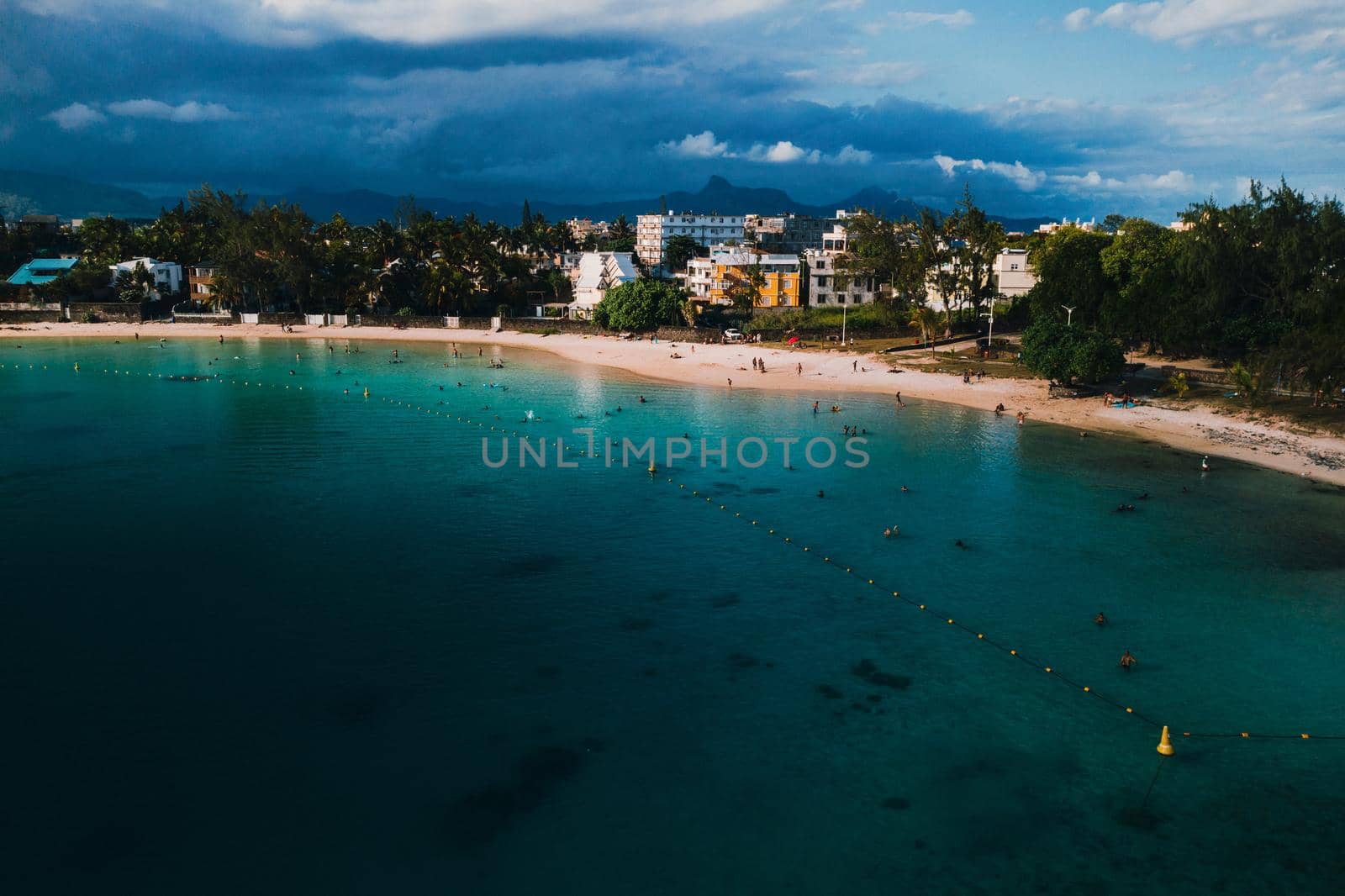 Aerial picture of the east coast of Mauritius Island. Beautiful lagoon of Mauritius Island shot from above. Boat sailing in turquoise lagoon.