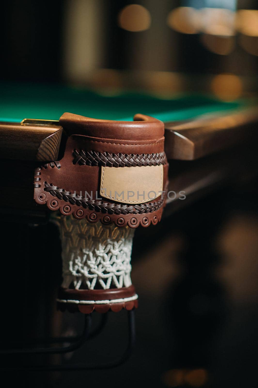 Leather decorative billiard hole and green table in the billiard club.