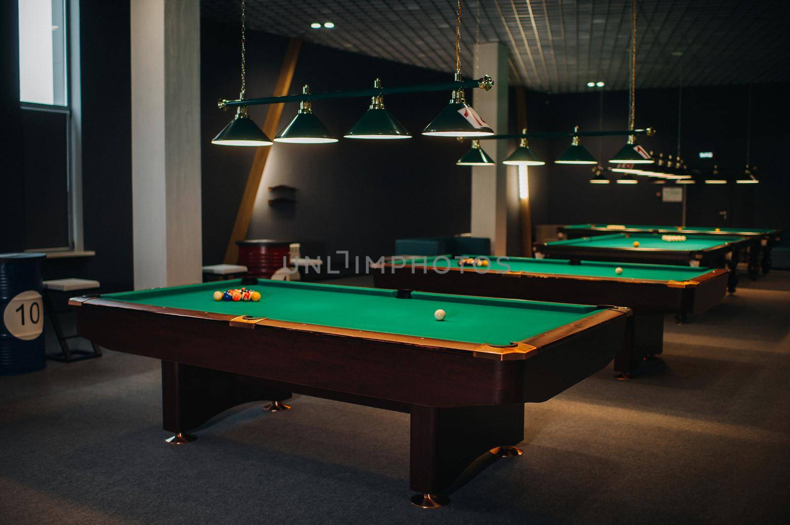 Billiard table with green surface and balls in the billiard club.Pool Game.