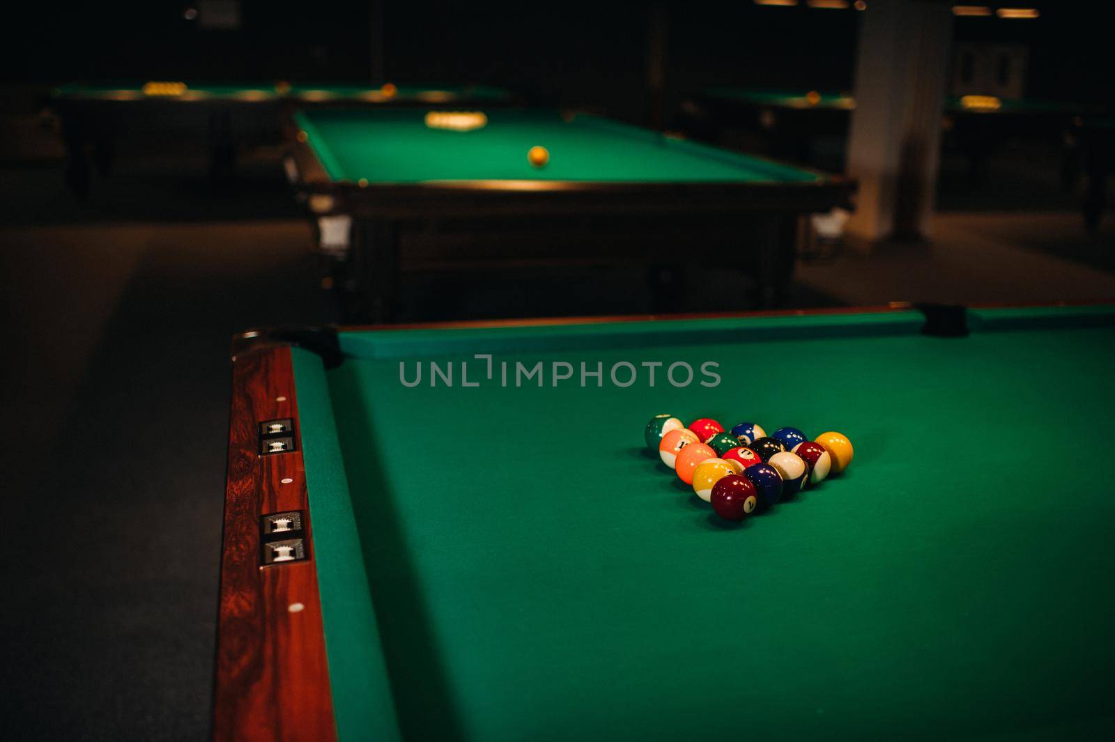 Billiard table with green surface and balls in the billiard club.Pool Game.