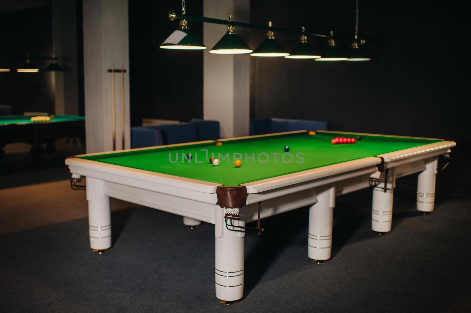 placing snooker balls on a green billiard table.