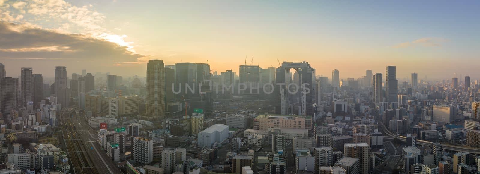 Aerial view of Osaka City Center, including Osaka Station and Umeda Sky Building on hazy winter morning in burning season