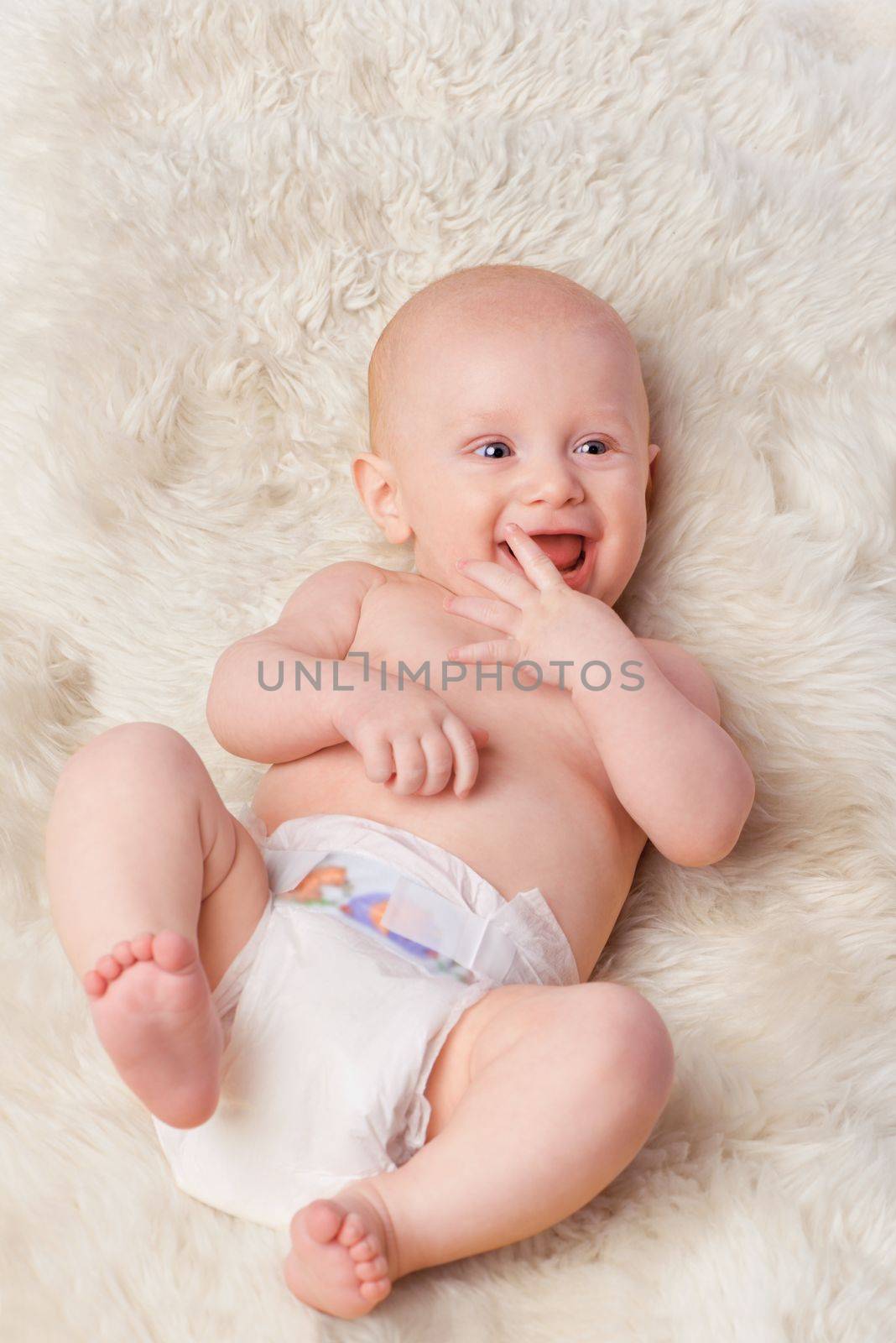 Hes his moms little angel. an adorable baby boy in a studio. by YuriArcurs