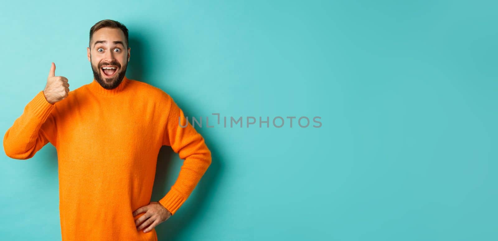 Well done. Handsome bearded man showing thumb up, praising good work, recommend excellent product, like and approve, smiling satisfied, standing over light blue background by Benzoix