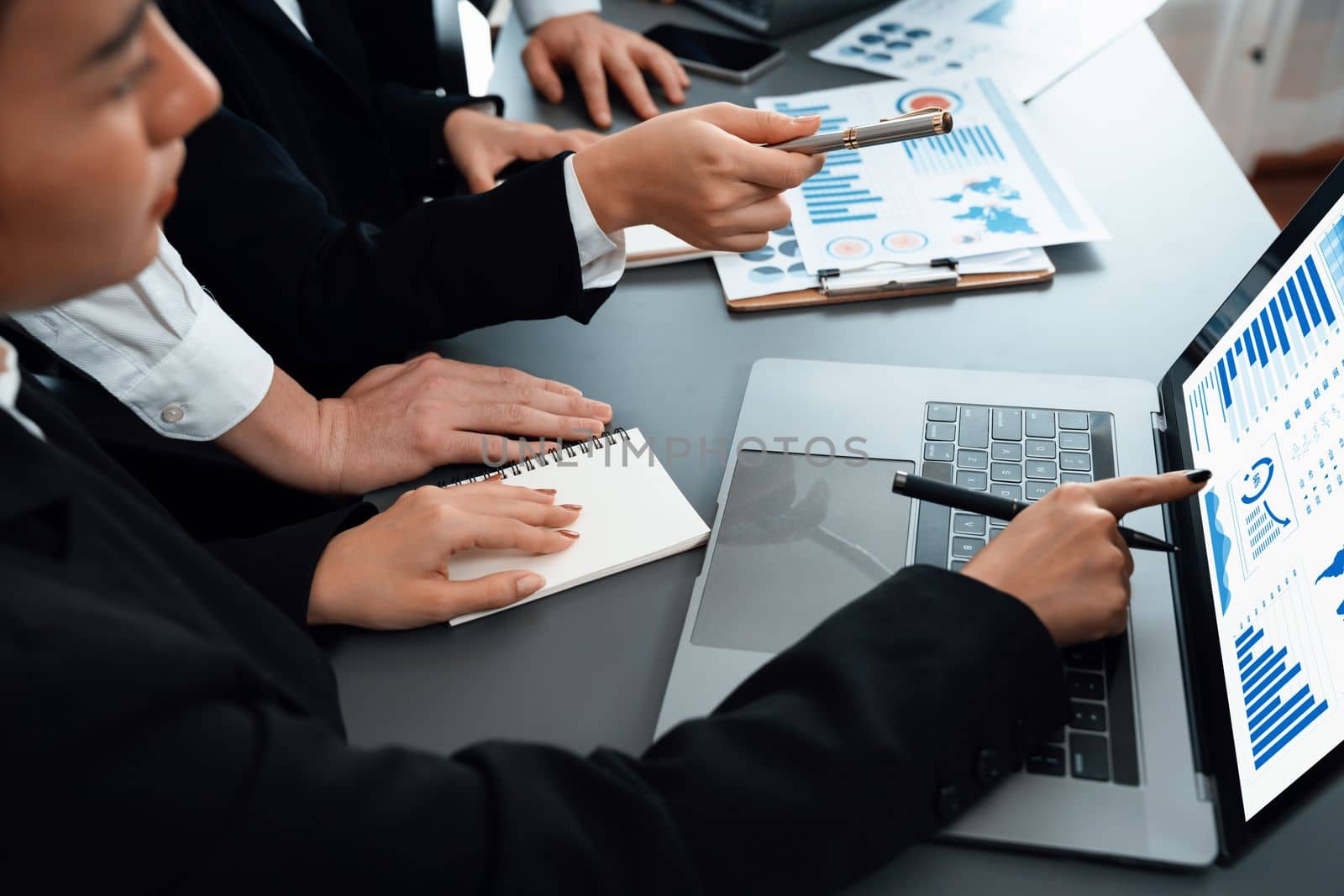 Closeup business team of financial data analysis meeting with business intelligence, report paper and dashboard on laptop for marketing. Business people working together in harmony office.