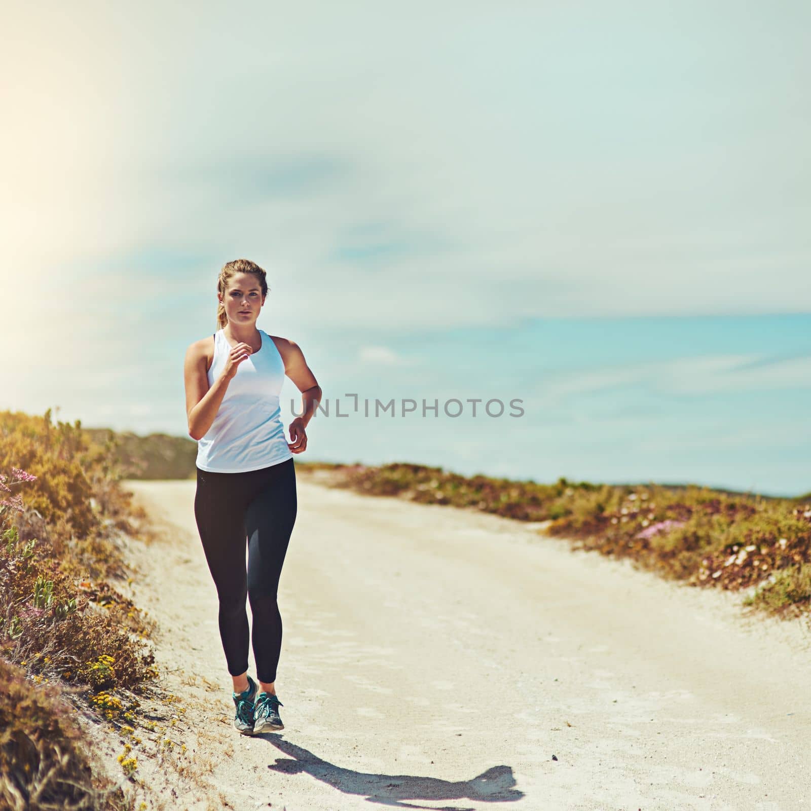 Running away yet running into nature is something amazing. a sporty young woman jogging outdoors