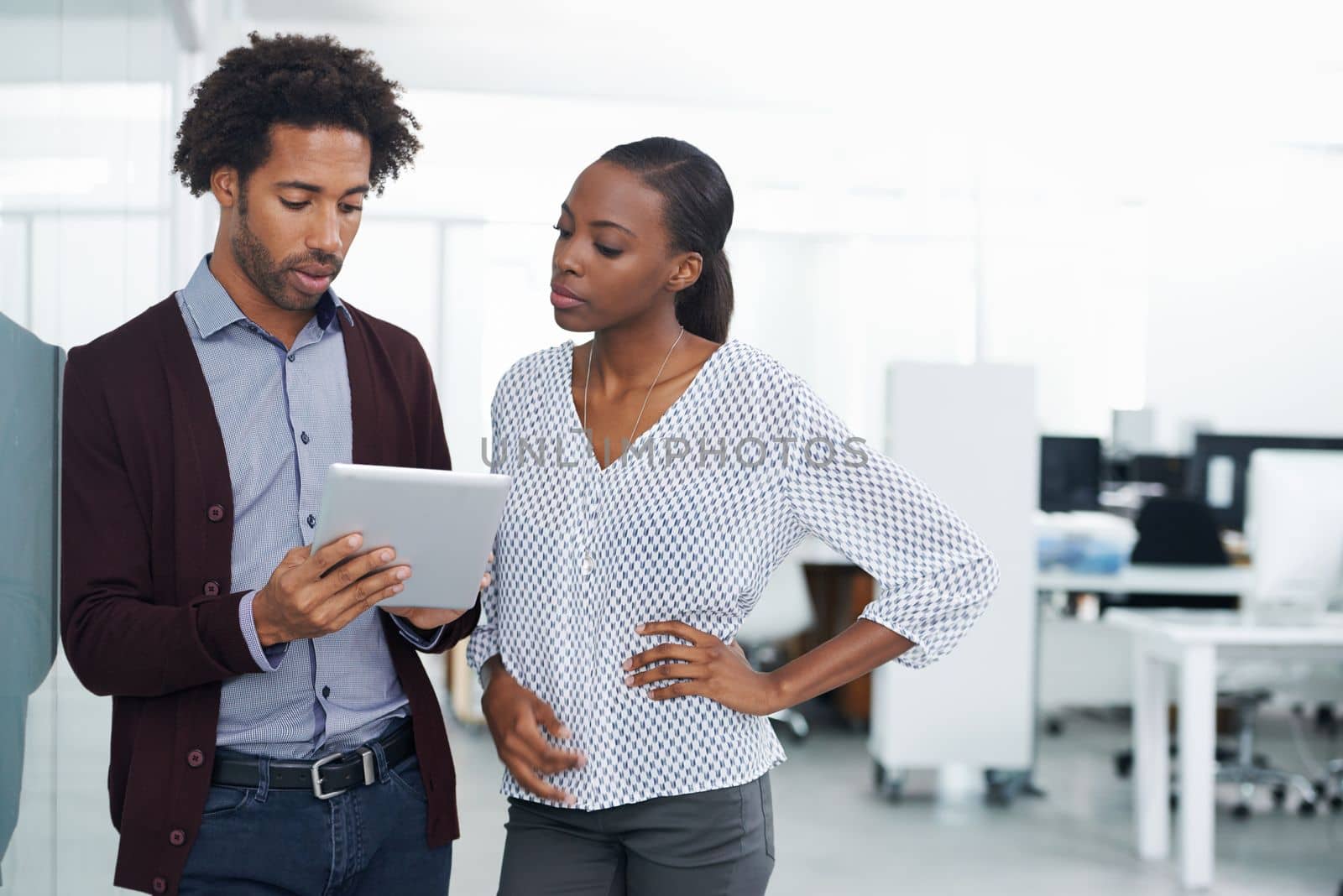 Another practical use for technology in the workplace. two colleagues using a digital tablet in an office