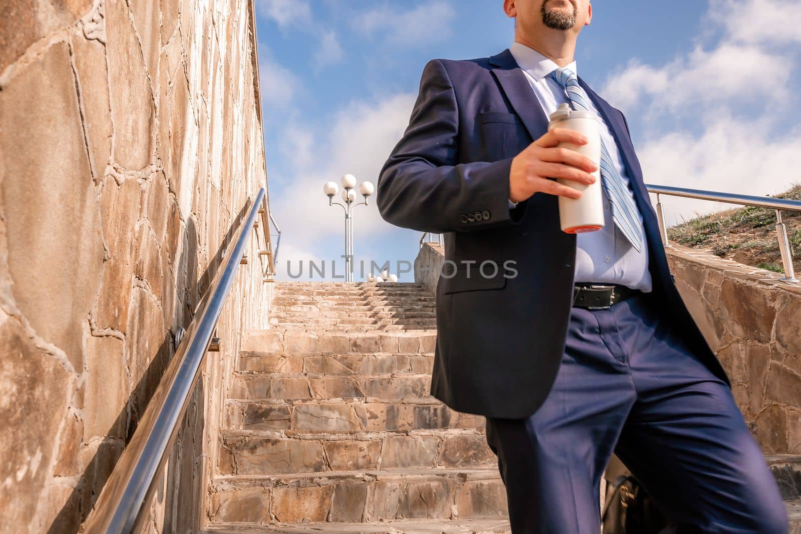 Business executive with briefcase going down the stairs.