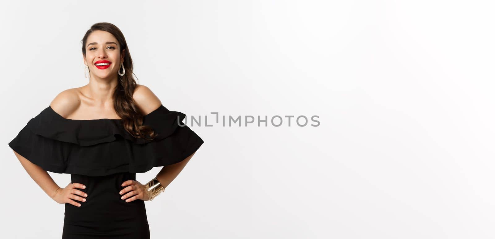 Beauty and fashion concept. Elegant young woman wearing party dress and red lipstick, laughing at camera, standing cheerful against white background by Benzoix