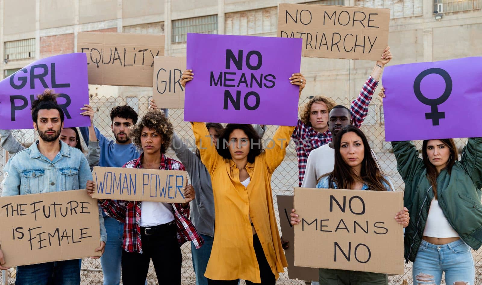 Group of multi-ethnic feminism activist protesting for women empowerment holding banners. No means no movement. Equality concept.