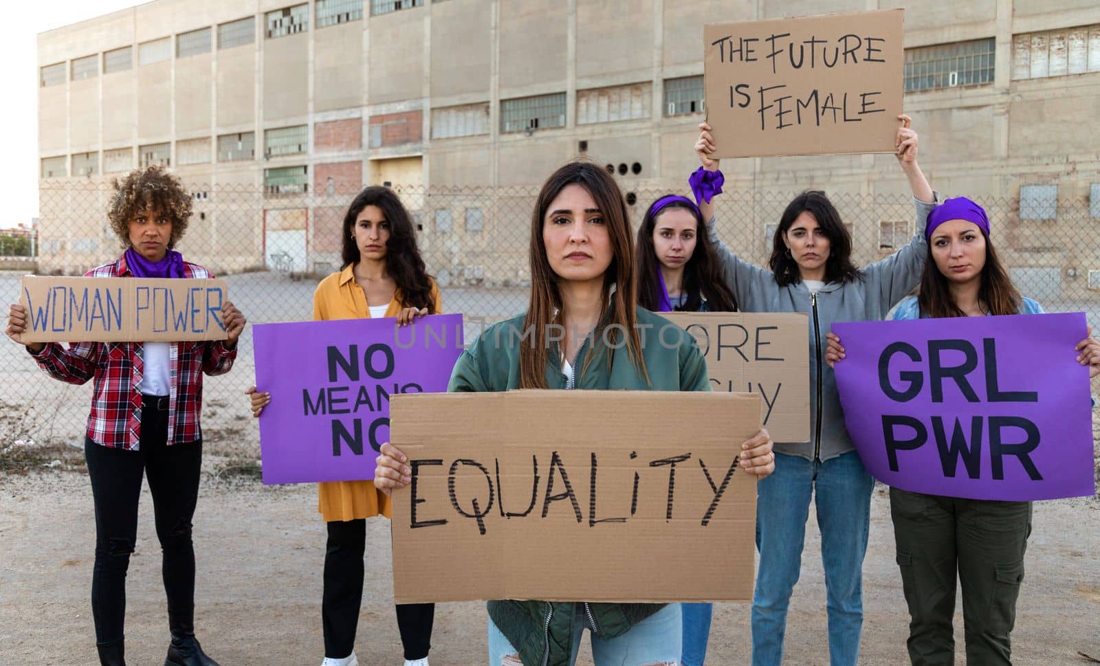 Confident group of multiracial women looking at camera holding feminist signboards protesting for women empowerment. Panoramic banner. Equality concept.