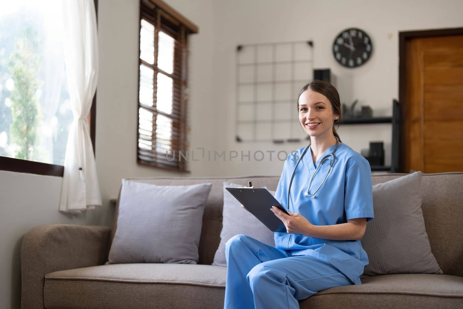 Portrait of a young Asian nurse or caregiver at home.Concept healthcare, profession, people and medicine..