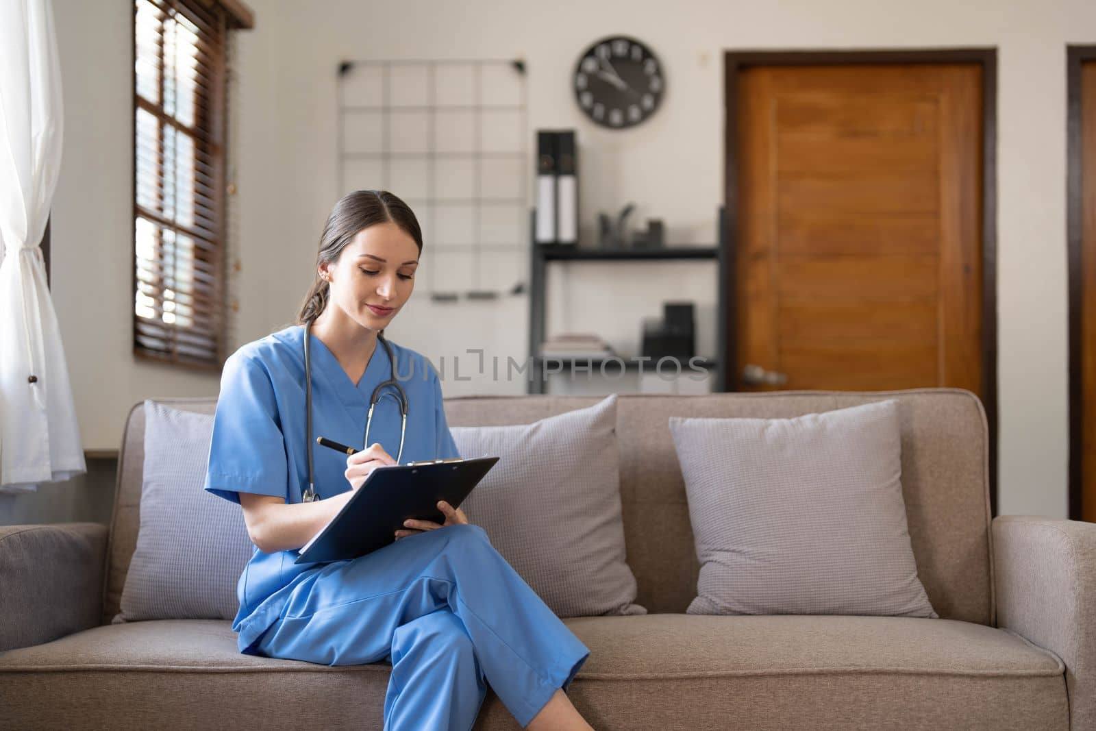 Portrait of a young Asian nurse or caregiver at home.Concept healthcare, profession, people and medicine..