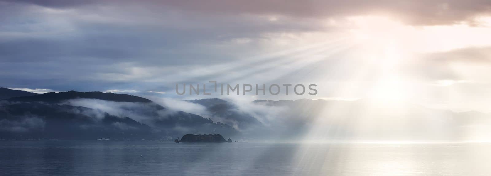 A photo of Sunset, ocean and mountains.