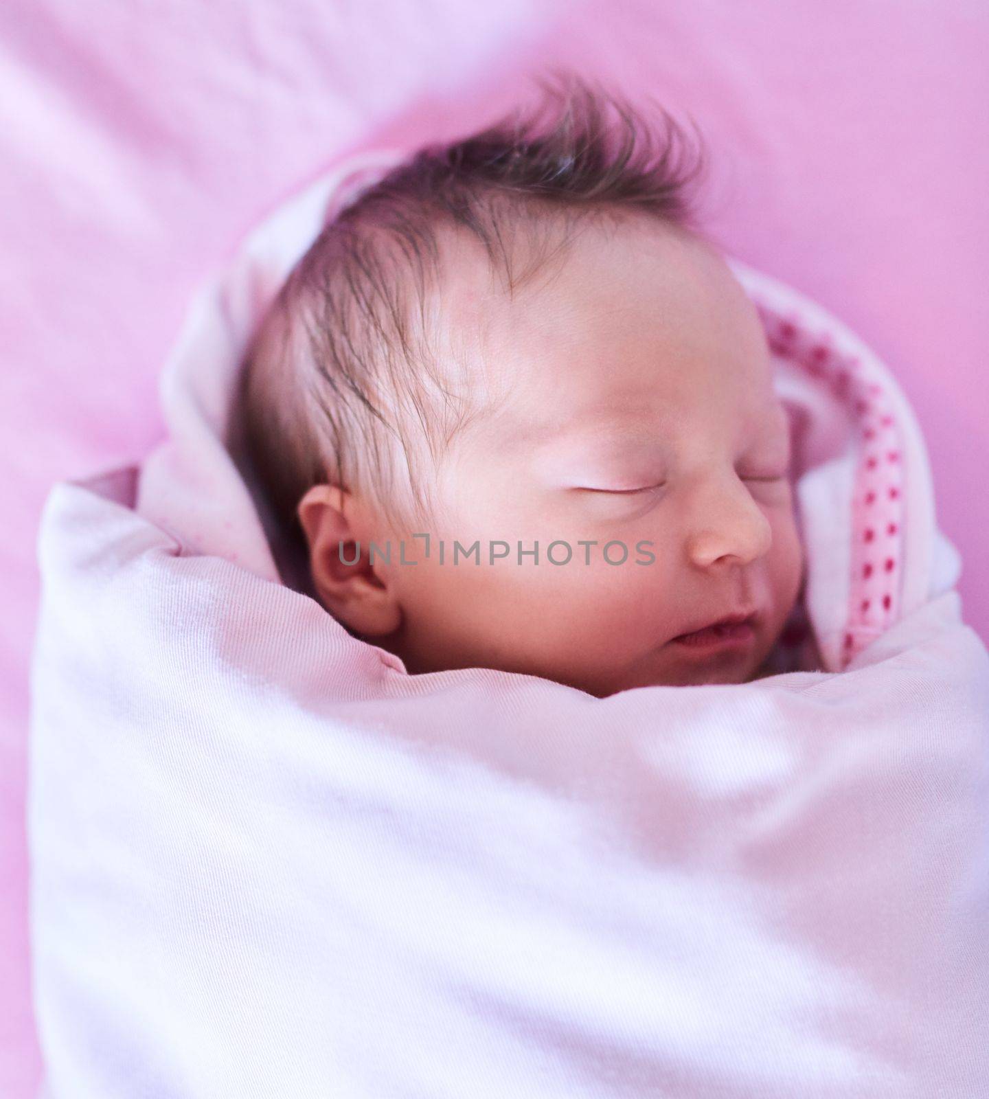 Shes one dream of ours that came to life. a newly born baby girl wrapped in a blanket in the hospital. by YuriArcurs