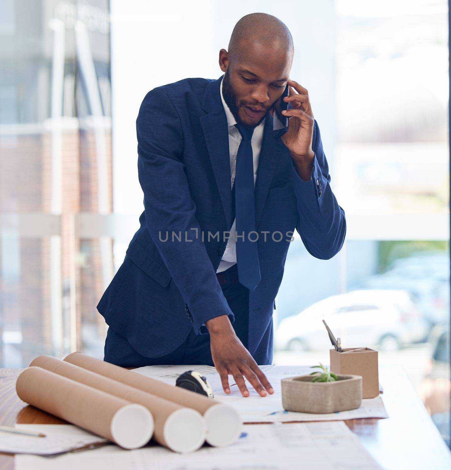 Architect, business and black man on phone call and blueprint, communication and contact with networking or phone meeting. Planning, businessman and architecture, mobile and building design review