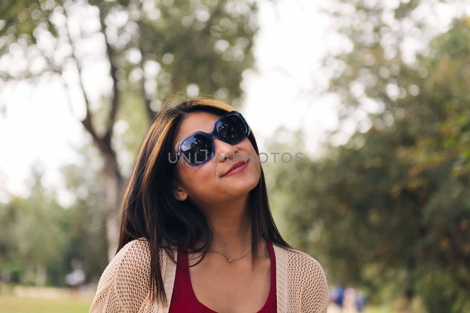 young asian woman with sunglasses smiling playful, concept of youth and beauty, copy space for text