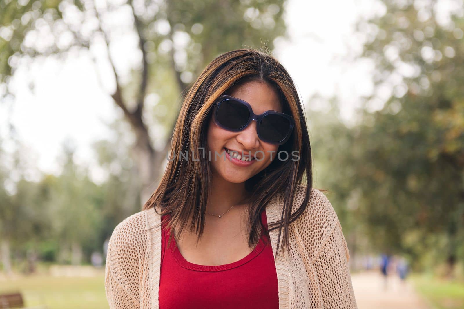 young asian woman with sunglasses smiling looking at camera, concept of youth and beauty, copy space for text