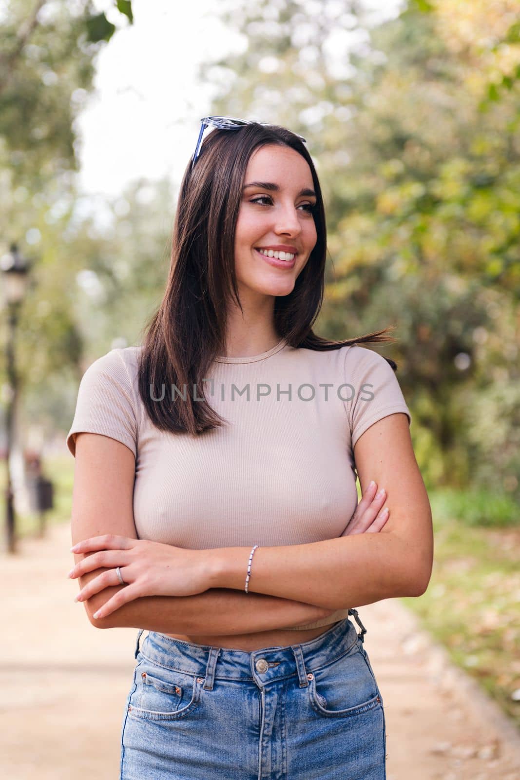 young caucasian woman with arms crossed smiling, concept of youth and beauty