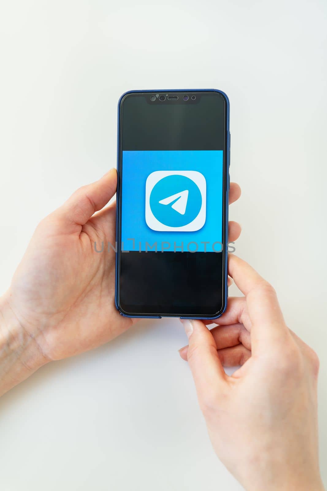Rivne, Ukraine - December 13, 2022: Telegram mobile application icon on iPhone smartphone screen macro. Telegram is a cross-platform messenger