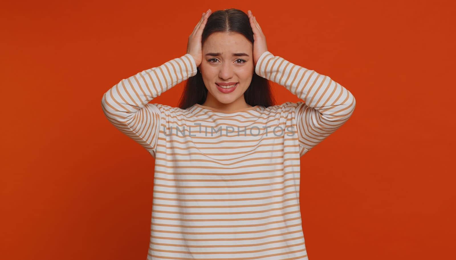 Dont want to hear and listen. Frustrated annoyed irritated one pretty woman covering ears gesturing No, avoiding advice ignoring unpleasant noise loud voices. Young girl on studio red background