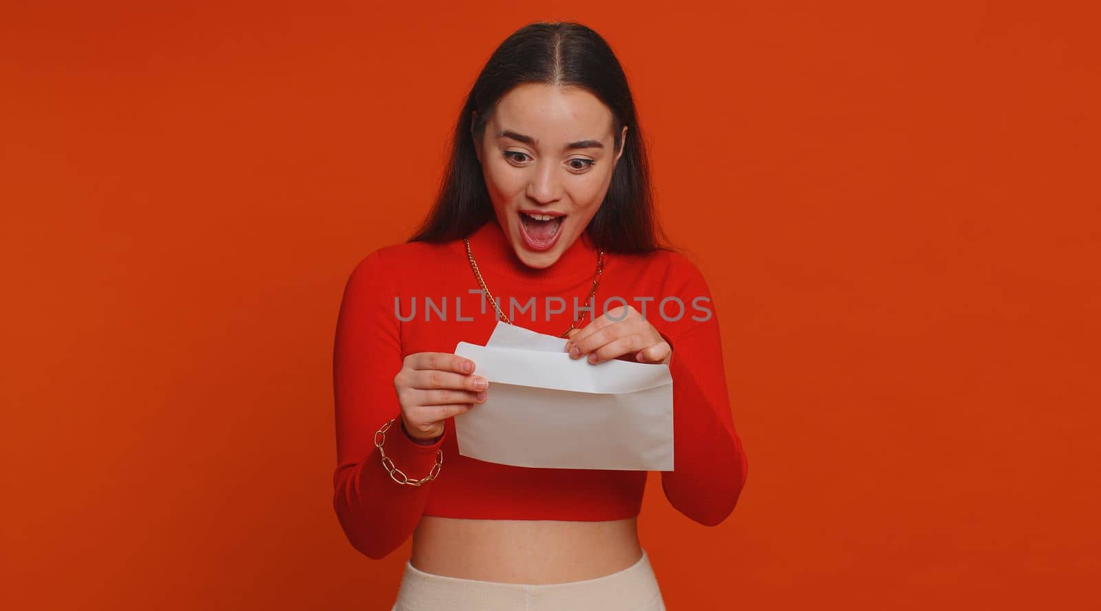 Young pretty student woman open envelope take out letter reads it feel happy. Girl career growth advance promotion, bank loan approve, monetary award, long-awaited invitation great news, lottery win