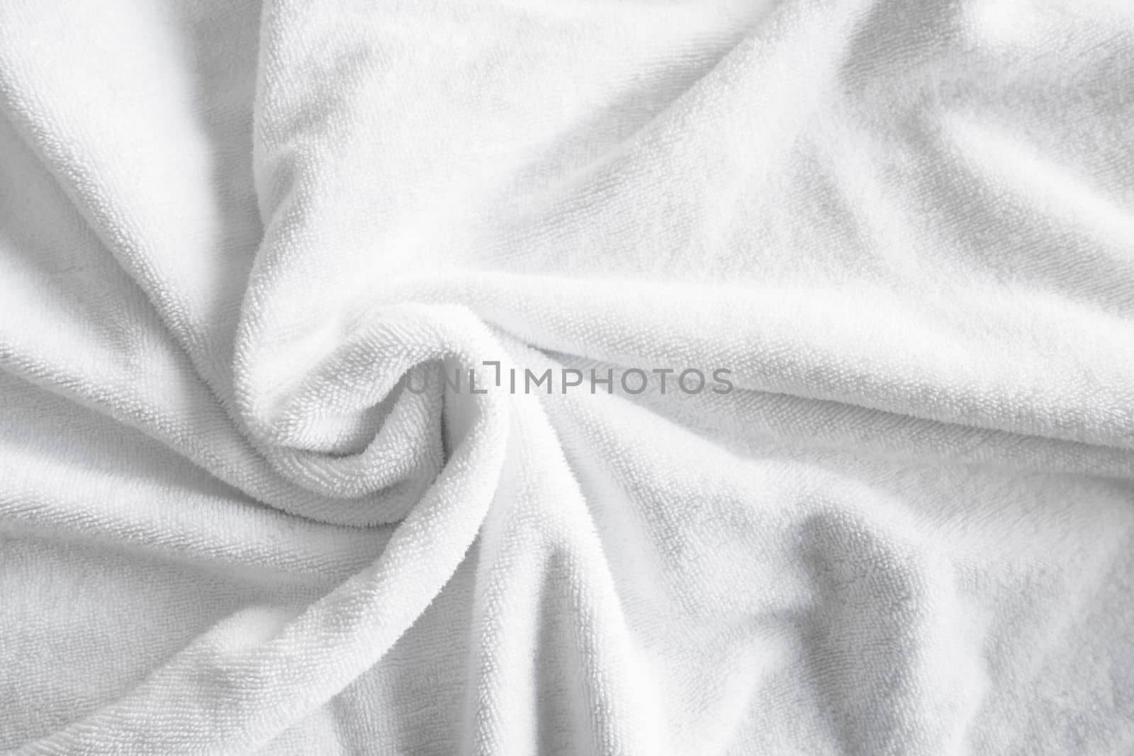 Textured white natural cotton towel background photo with selective focus.