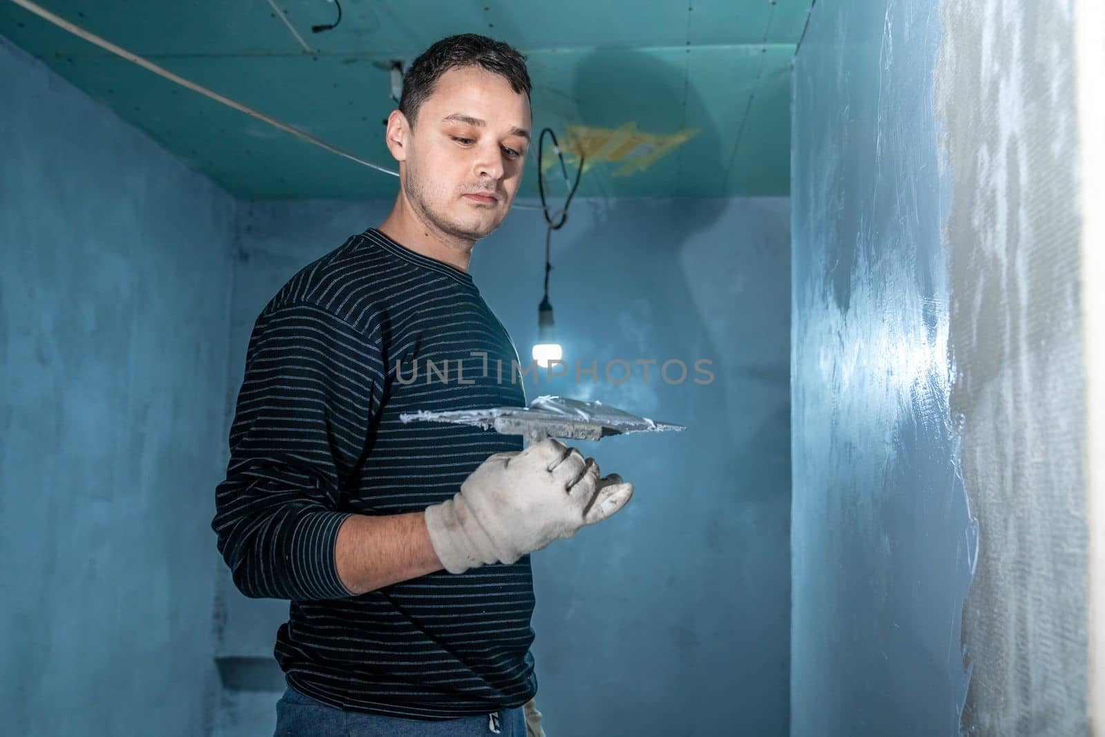insulation of a concrete wall against moisture with the use of a trowel. High quality photo