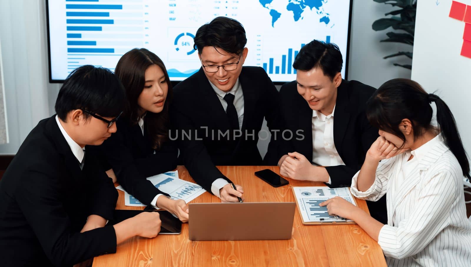 Business team of financial data analysis meeting with business intelligence, report paper and dashboard on laptop for marketing strategy. Business people working together to promote harmony in office.