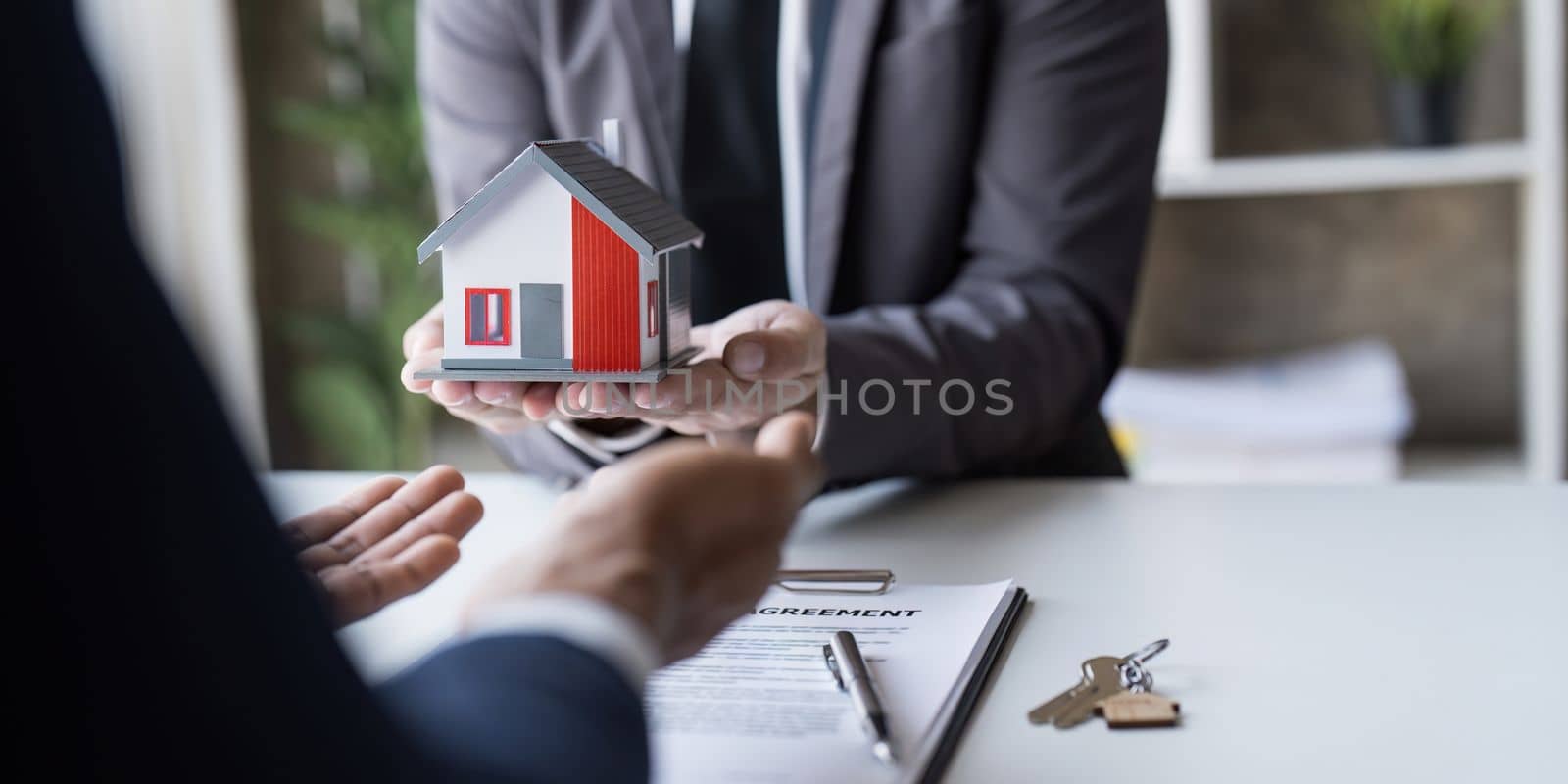 The house selling broker holds the keys and the model house is given to the customers,Real estate concept